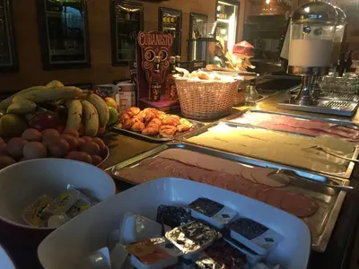 a counter with a bunch of different types of food at Auberge des 3 Fontaines - Youth Hostel in Brussels