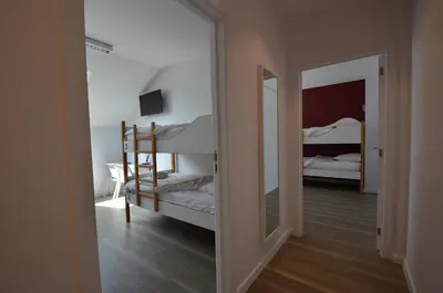 a bedroom with two bunk beds and a mirror at Auberge des 3 Fontaines - Youth Hostel in Brussels