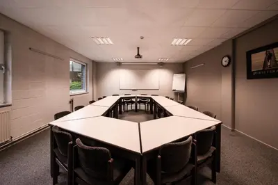a conference room with a long table and chairs at Auberge des 3 Fontaines - Youth Hostel in Brussels