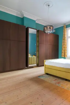 a bedroom with a bed and wooden cabinets at Garden of Eden in Antwerp