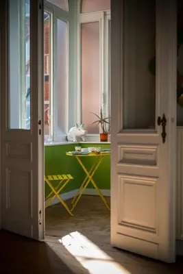 a door leading to a room with a window and a table at Garden of Eden in Antwerp