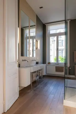 a bathroom with two sinks and a large mirror at Garden of Eden in Antwerp