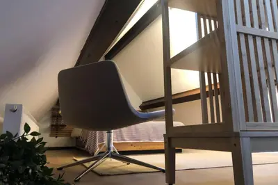 a chair sitting in front of a staircase at Easy comfort in Brussels