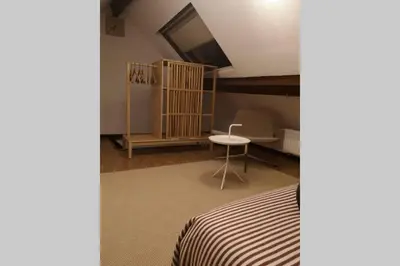 a bedroom with a bed and a table and a chair at Easy comfort in Brussels
