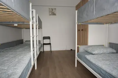 a bedroom with two bunk beds and a chair at Belga Apartment 3 bedrooms. in Antwerp