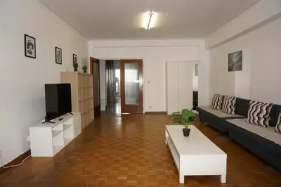 a living room with a couch and a tv at Belga Apartment 3 bedrooms. in Antwerp
