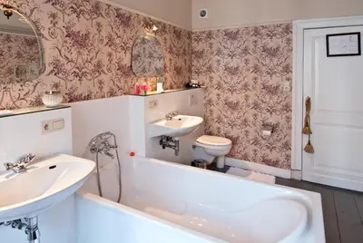 a bathroom with a tub and a sink and a toilet at B&B The Baron in Antwerp