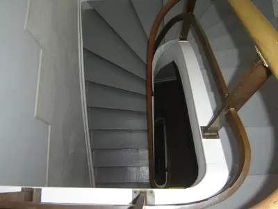 a spiral staircase with a mirror in a room at B&B The Baron in Antwerp