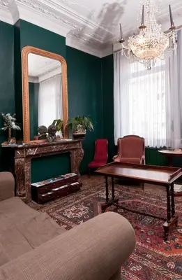 a living room with a mirror and a table at B&B The Baron in Antwerp