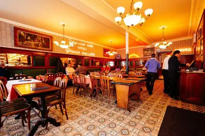 a restaurant with people sitting at tables in a restaurant at Hotel Soret in Overijse