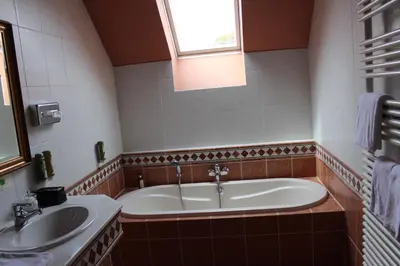 a bathroom with two sinks and a bath tub at Hotel De Notelaer in Bornem