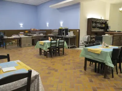 a dining room with tables and chairs in a room at Hotel de la Gare Aalst in Aalst
