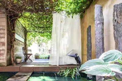 a patio with a pool of water and a white curtain at Chambreplus Kriski in Ghent