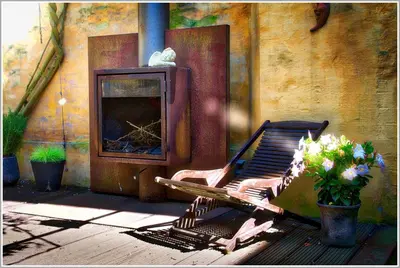 a rocking chair sitting in front of a fireplace at Chambreplus Kriski in Ghent