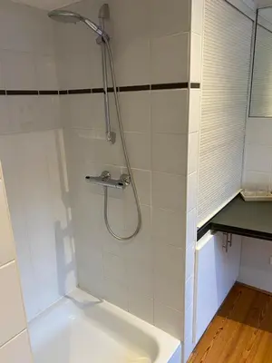 a bathroom with a shower and a tub at Chambreplus Kriski in Ghent