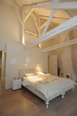 a bedroom with a large bed with a loft at Chambreplus Kriski in Ghent