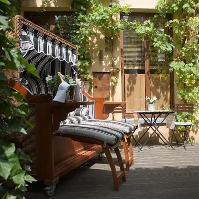 a row of benches sitting on a patio at Chambreplus Kriski in Ghent