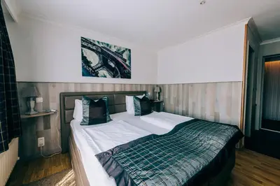 a bedroom with a large bed in a room at Hotel De Kalvaar in Ninove