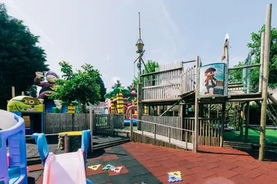 a park with a playground with a roller coaster at Hotel De Kalvaar in Ninove