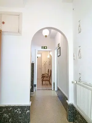 a hallway with an archway leading to a dining room at Logies Hanssen in Beveren