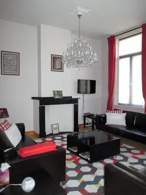 a living room with a couch and a fireplace at Apartments Suites in Antwerp in Antwerp
