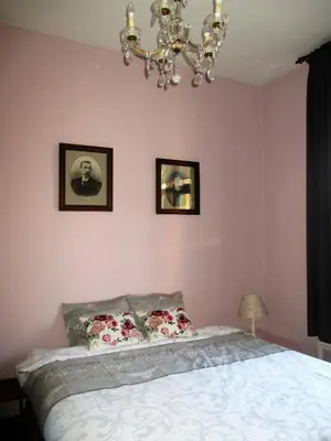 a bedroom with a bed and two pictures on the wall at Apartments Suites in Antwerp in Antwerp