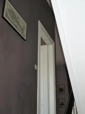 an archway mirror in a hallway with a door at Apartments Suites in Antwerp in Antwerp
