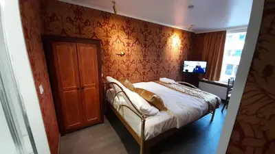 a bedroom with a bed and a wooden wall at Bosdam Budget Rooms in Beveren