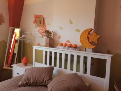 a childs bedroom with a crib with a moon and stars at B&B Marianne in Brussels