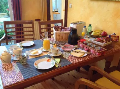 a table with breakfast foods and orange juice on it at B&B Marianne in Brussels
