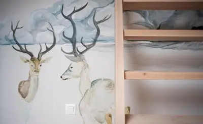a painting of two deer on a wall at KaBa Hostel in Ghent