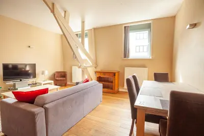 a living room with a couch and a table at Luxury Suites Castel by Rikas Hotels in Antwerp