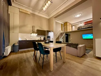 a kitchen and living room with a table and chairs at Luxury Suites Castel by Rikas Hotels in Antwerp