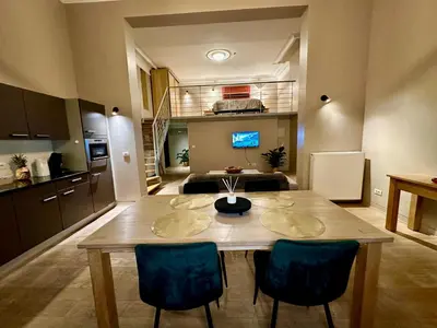 a kitchen and dining room with a table and chairs at Luxury Suites Castel by Rikas Hotels in Antwerp