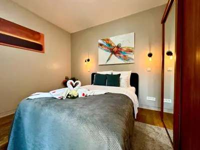 a bedroom with a bed with a flower on it at Luxury Suites Castel by Rikas Hotels in Antwerp