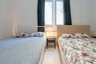 a bedroom with a bed and a window at Beautiful Cozy Apartments in the Heart of Antwerp in Antwerp