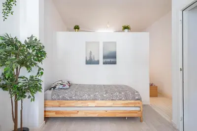 a bedroom with a bed in a white wall at Beautiful Cozy Apartments in the Heart of Antwerp in Antwerp