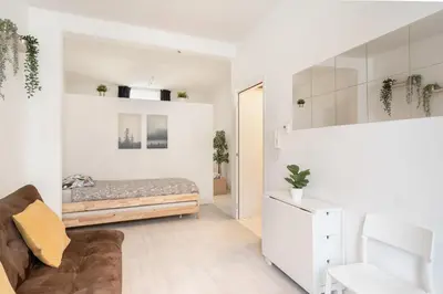 a living room with a bed and a couch at Beautiful Cozy Apartments in the Heart of Antwerp in Antwerp