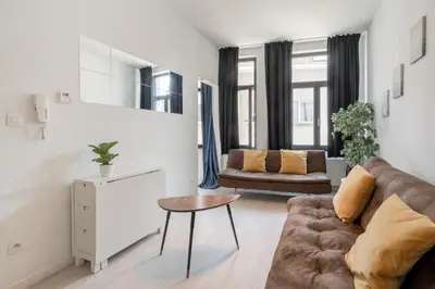a living room with a couch and a table at Beautiful Cozy Apartments in the Heart of Antwerp in Antwerp