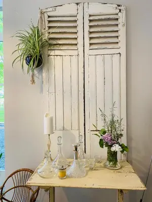 a table with vases and flowers on top of it at Cosy house in a charming village in Beauvechain