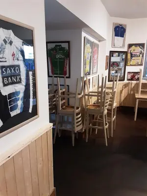 a dining room with chairs and posters on the wall at ’t Wielerpension in Steenhuize-Wijnhuize