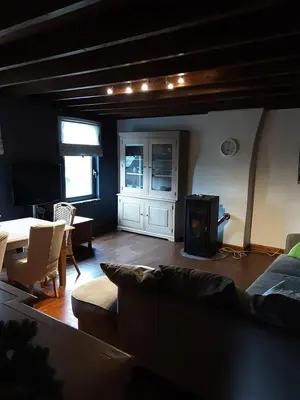 a living room with a couch and a table at ’t Wielerpension in Steenhuize-Wijnhuize