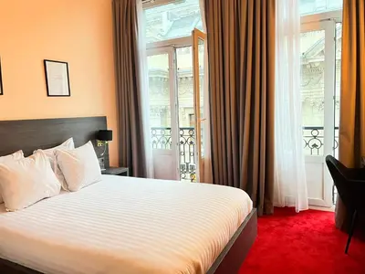a hotel room with a bed and a window at La Bourse Hotel in Brussels