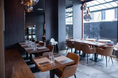 a dining room with wooden tables and chairs at La Bourse Hotel in Brussels