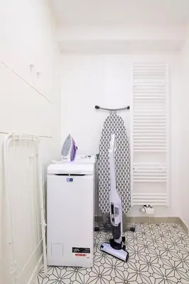 a room with a white refrigerator and a hair dryer at THE GOOD FLATS in Brussels
