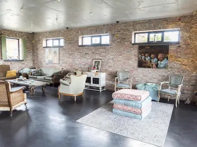 a living room filled with furniture and a brick wall at De Lieshoeve in Arendonk