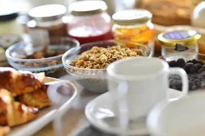 a table topped with bowls of food and other ingredients at B&B Entre Champs in Ohain