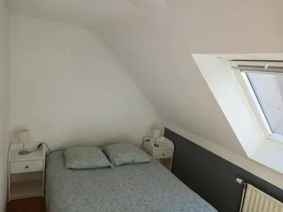 a small bedroom with a bed and a window at Résidences De Champles in Bierges