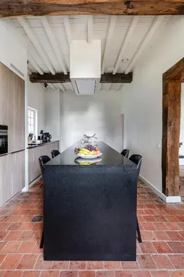 a black table with a plate of food on it at Beddermolen - Molenhuis op historisch erfgoeddomein in Westerlo