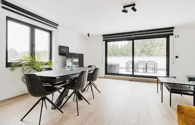 a living room with a dining room table and chairs at Résidence Palace Expo in Brussels